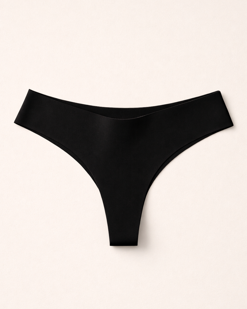 Schwarzer Seamless Tanga liegend – minimalistisches Design und ultraleichtes Material.